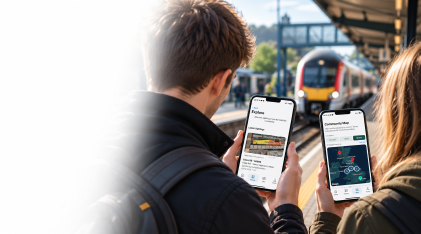 Railway enthusiasts using RailFolio on their phones at a station